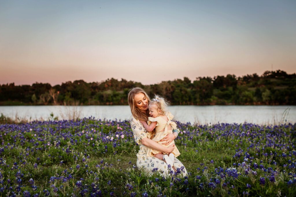 little girl with blonde pigtails in bluebonnet field with mom family session at brushy creek-11