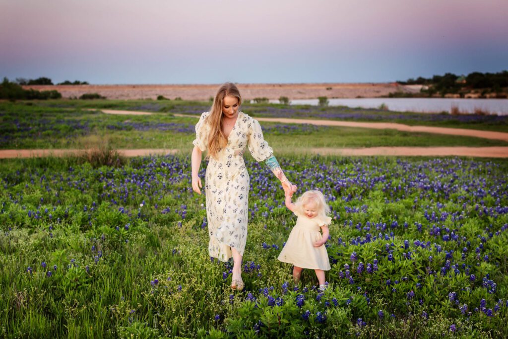 little girl with blonde pigtails in bluebonnet field with mom family session at brushy creek-14
