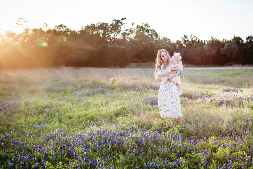 little girl with blonde pigtails in bluebonnet field with mom family session at brushy creek-4