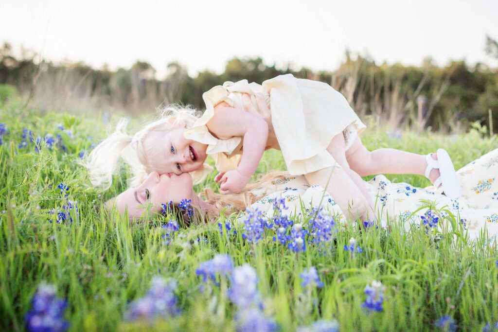 little girl with blonde pigtails in bluebonnet field with mom family session at brushy creek-5
