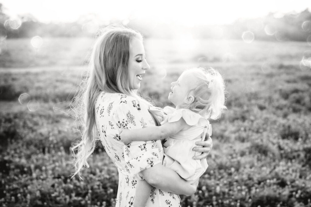 little girl with blonde pigtails in bluebonnet field with mom family session at brushy creek-9