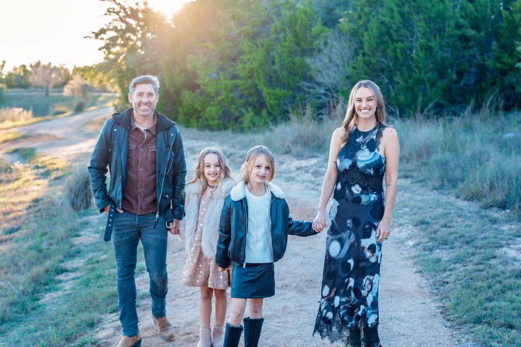 family of four walking on backlit path