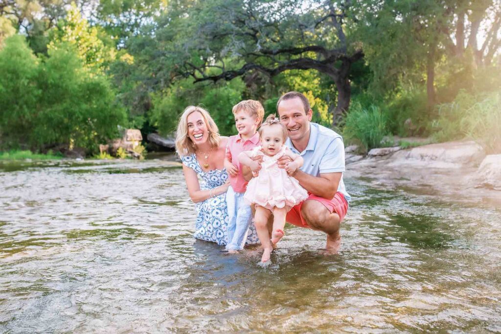 child laughing in shallow creek water Austin session